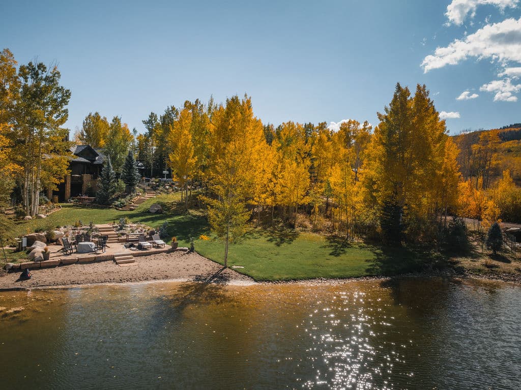 A pond and aspens on a valley property in autumn